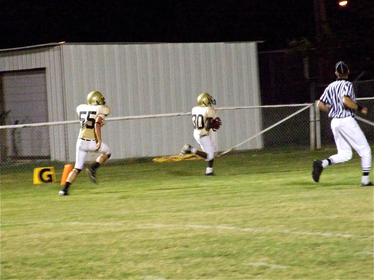 Image: In the final moments, Italy’s [Name Withheld](30) intercepts a Longhorn pass and runs it in for the game winning touchdown. Teammate Zackery Boykin(55) makes sure he gets there safely.