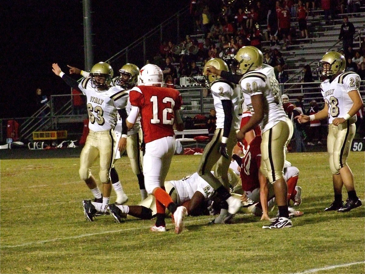 Image: Italy’s Bobby Wilson(64) recovers a fumble for the Gladiators — Brandon Souder(63), Jasenio Anderson(11) and De’Andre Rettig(60) signal Gladiators’ ball after Bobby Wilson(64) recovers an Axtell Longhorn fumble. Despite Italy’s best efforts, Axtell knocks the Gladiators out of the playoff race with a 35-28 win at Ellison Field in Axtell.