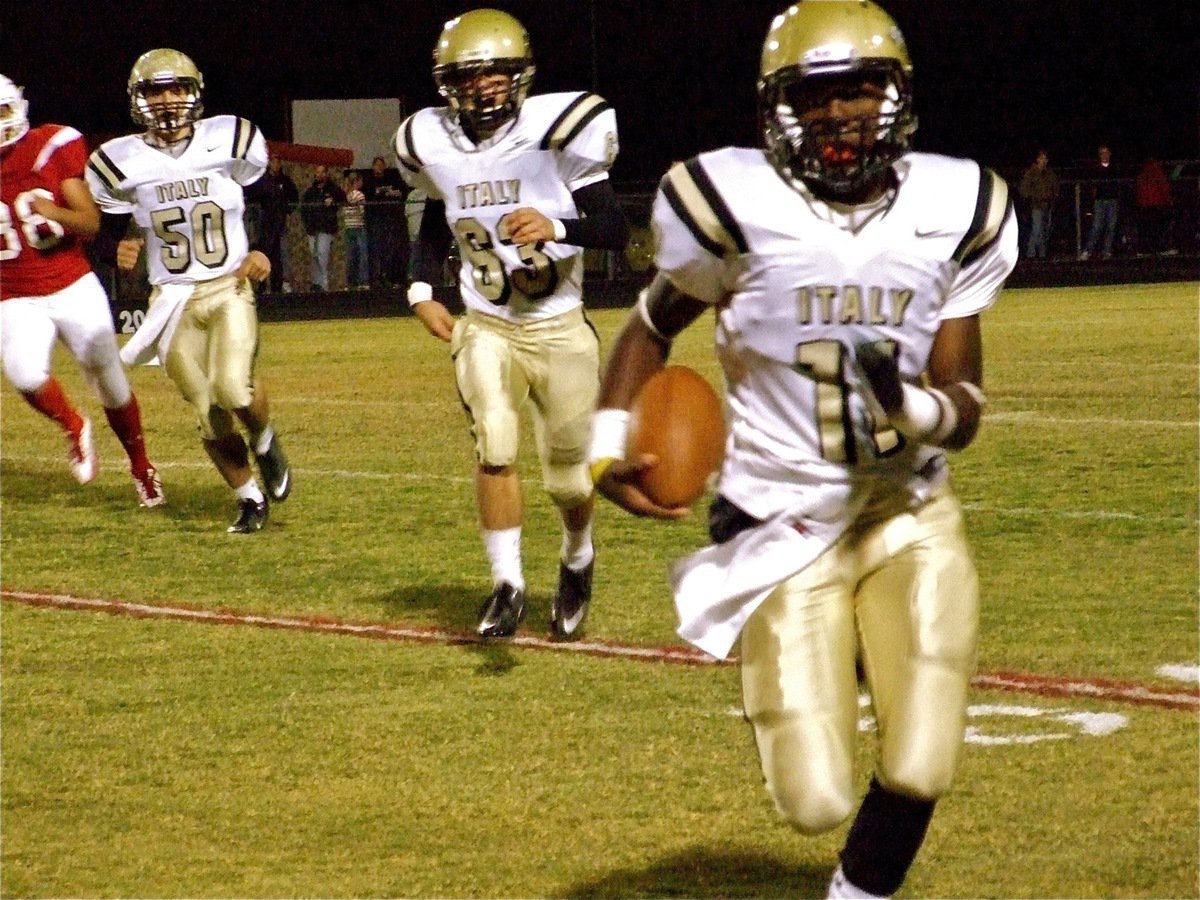 Image: Coming at you! — Gladiator quarterback Jasenio Anderson(11) gets help from his blockers, Ethan Simon(50) and Brandon Souder(63), and then heads for the first down marker.