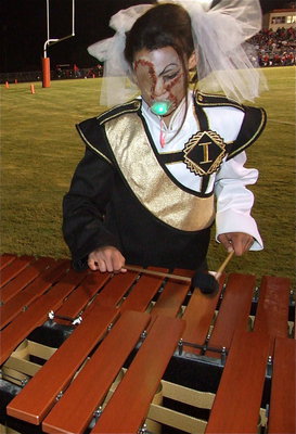 Image: Scary tunes — Alex Minton, who is ready for Halloween, plays a little number before the Gladiator Regiment Band and Flag Corp’s halftime performance.