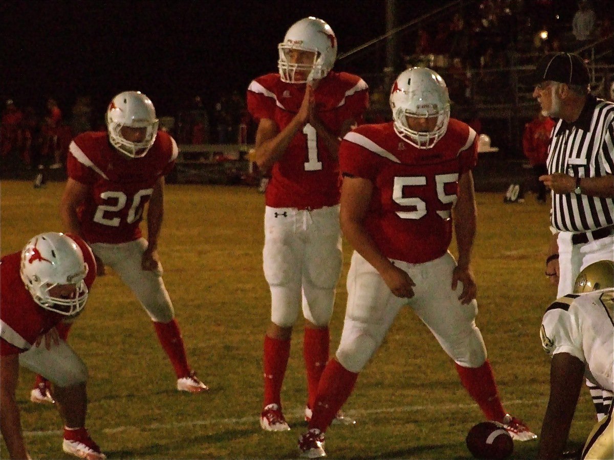 Image: One last prayer — Axtell’s quarterback Justin Stranacher(1) has his prayers answered as the Longhorns defeat the Gladiators 35-28 and remain undefeated in district.