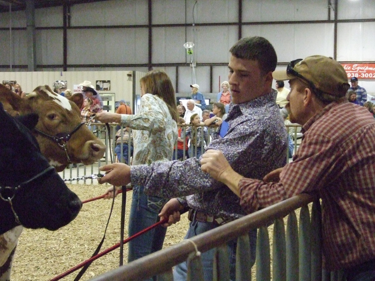 Image: Ethan and Mr. “D” — Ethan Saxon and Sonny Dickerson, Italy FFA teacher, talk about showing his steer.