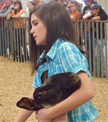 Image: We did it! — Cassidy Childers overcomes her nerves during her first experience showing an animal at the Ellis County Expo. Her lamb was completely confident as well.