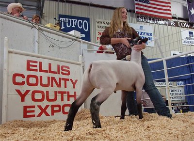Image: Lewis and her lamb — Jaclynn Lewis displays her lamb during the sale.