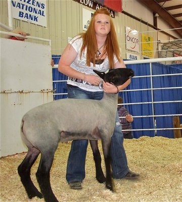 Image: Katie Byers — Katie Byers displays her lamb during the Expo sale.