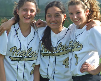 Image: Standing together — Paola Mata, Lupita Luna and Morgan Cockerham played big roles in the Italy Lady Gladiators J.V. Softball Team’s win over Red Oak J.V. on Monday.