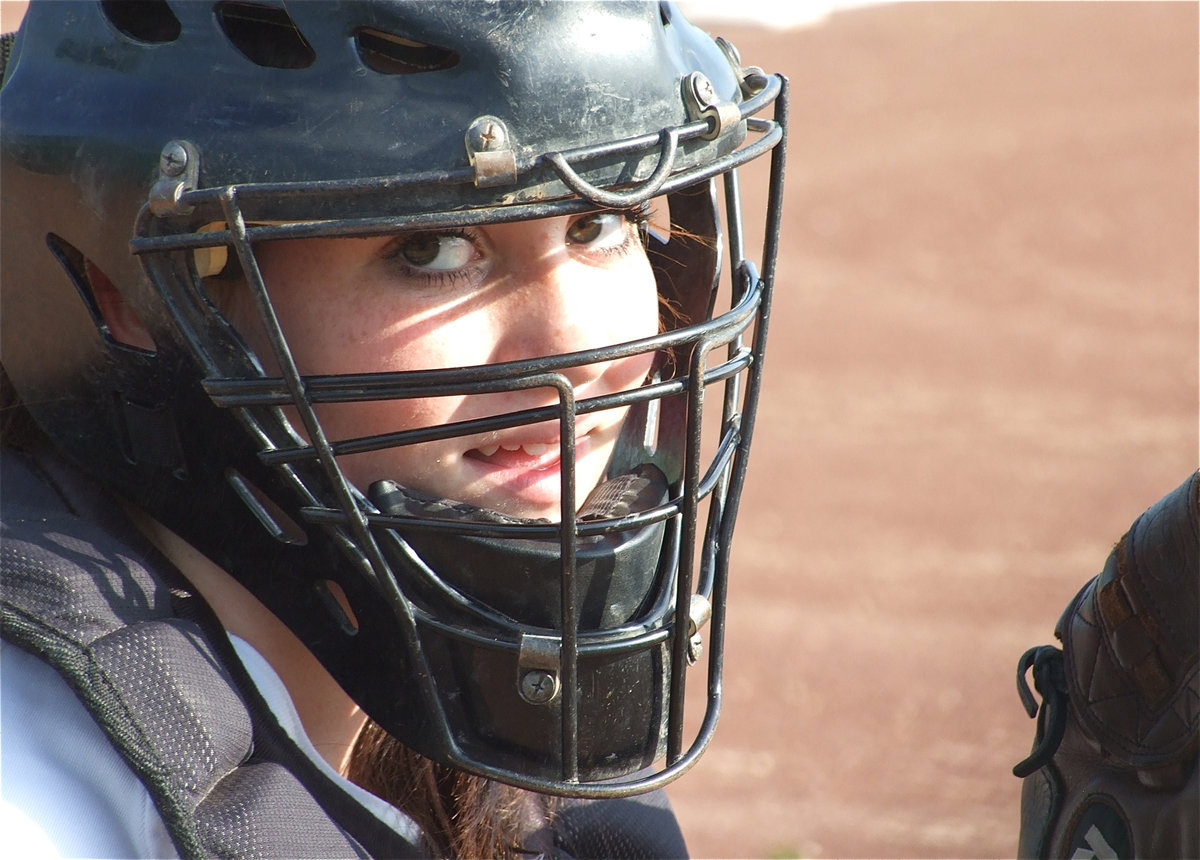 Image: Catching a peek — Italy catcher Breyanna Beets peers thru her mask.