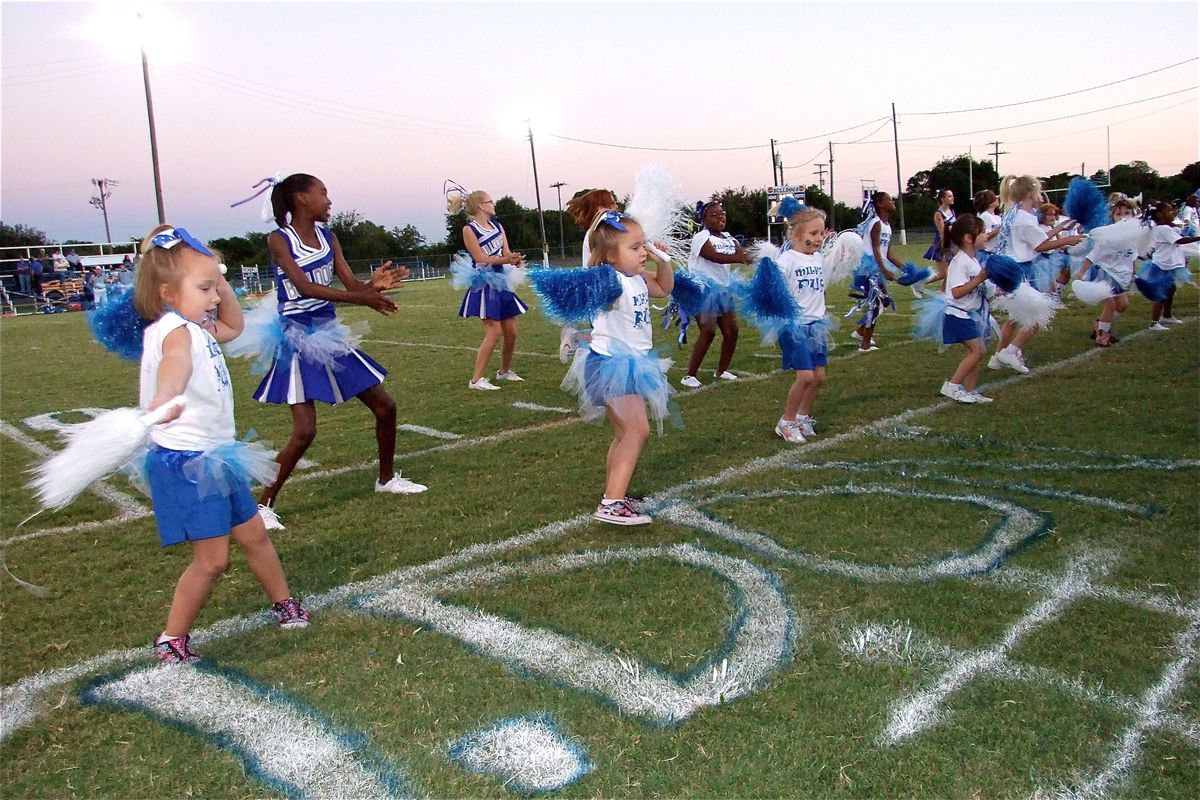 Image: Who let the pups out? — The Milford Pups and Milford’s Junior High Cheerleaders had all the right moves.