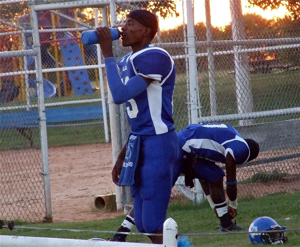 Image: Thirsty ‘Dawg’ — Milford Bulldog A.D. Hightower(13) takes a drink before the chase.