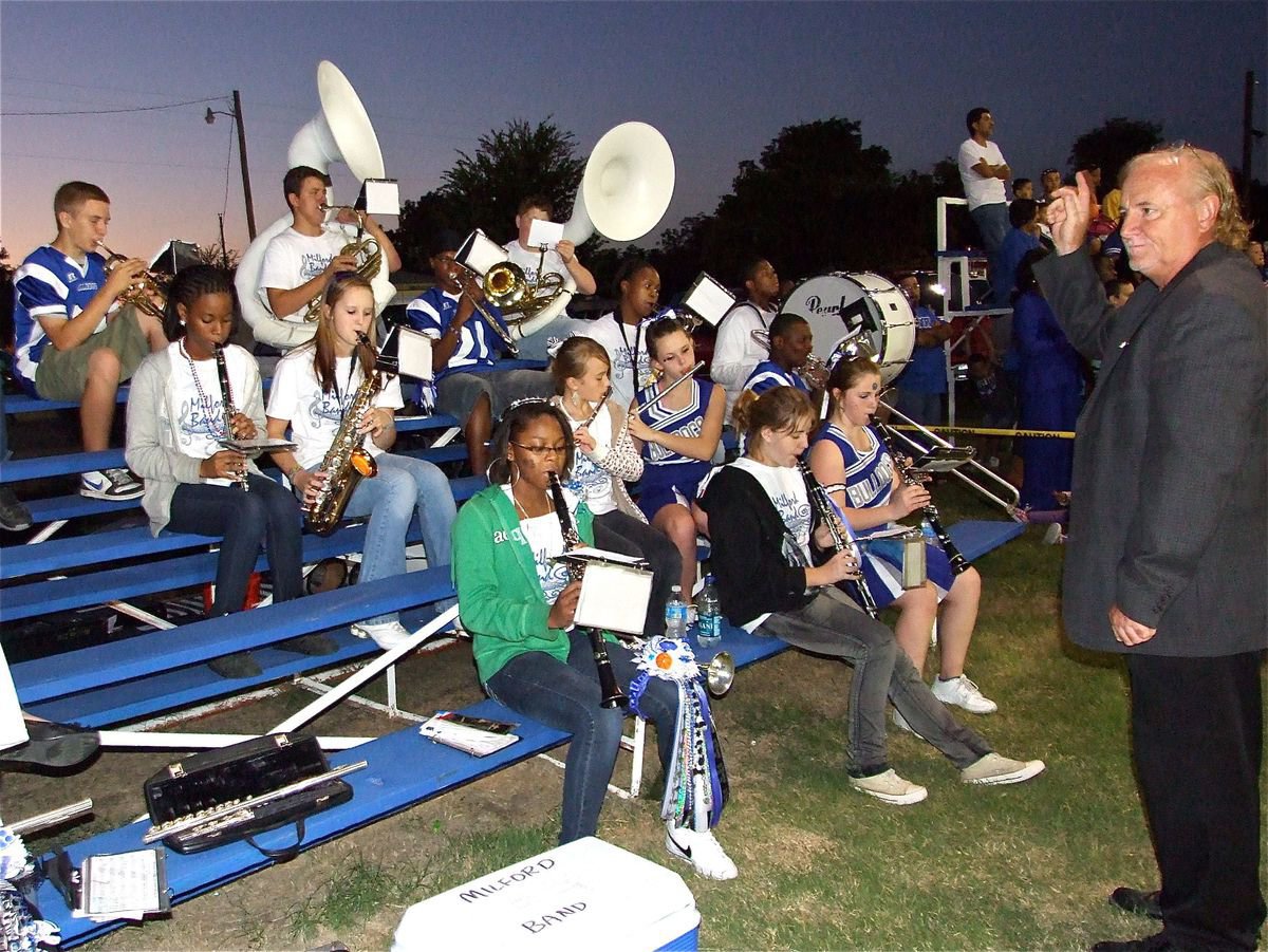 Image: And a one, and a two…. — MHS Band director Mike Trussell guides his musicians throughout the game.