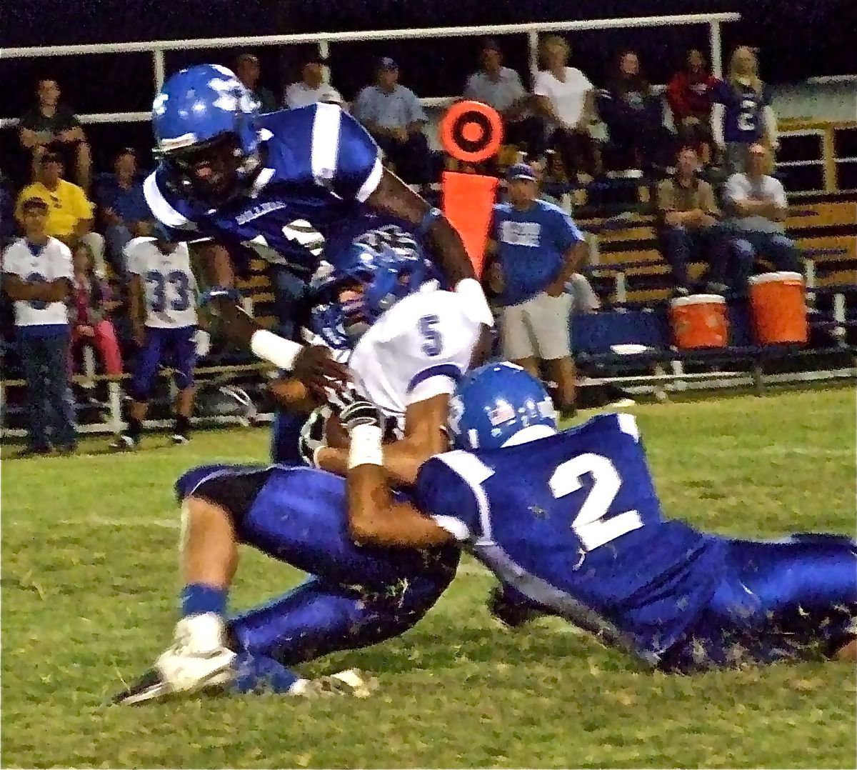 Image: Swarming the Hornets — Milford Bulldogs’s Ernest Lee Smith(11) and Rolando Vega(2) swarm Walnut Springs Hornet Ryan Engelhardt(5) as the Bulldogs invoke the mercy rule in the third quarter to win their Homecoming game 52-6 over the Hornets