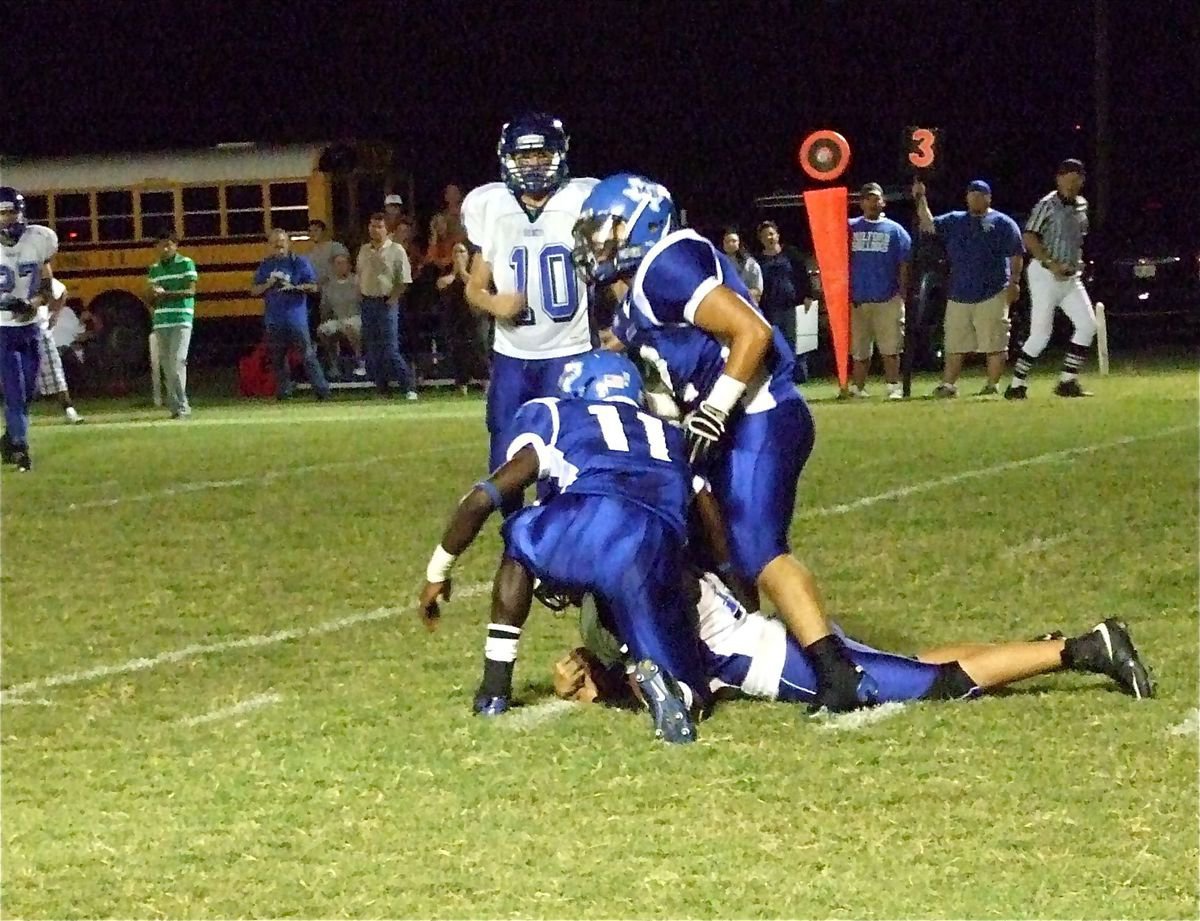 Image: Hornet gets sacked — Milford Bulldogs’s Earnest Lee Smith(11) and Rolando Vega(2) sack the Walnut Springs quarterback on the three yard line of the Hornets.