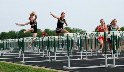 Image: Up and over — Taylor Turner and Bailey Bumpus finish in 3rd and 4th place while teammate, Imke Klindworth, finishes in 5th place during the JV girls 100 meter hurdles.