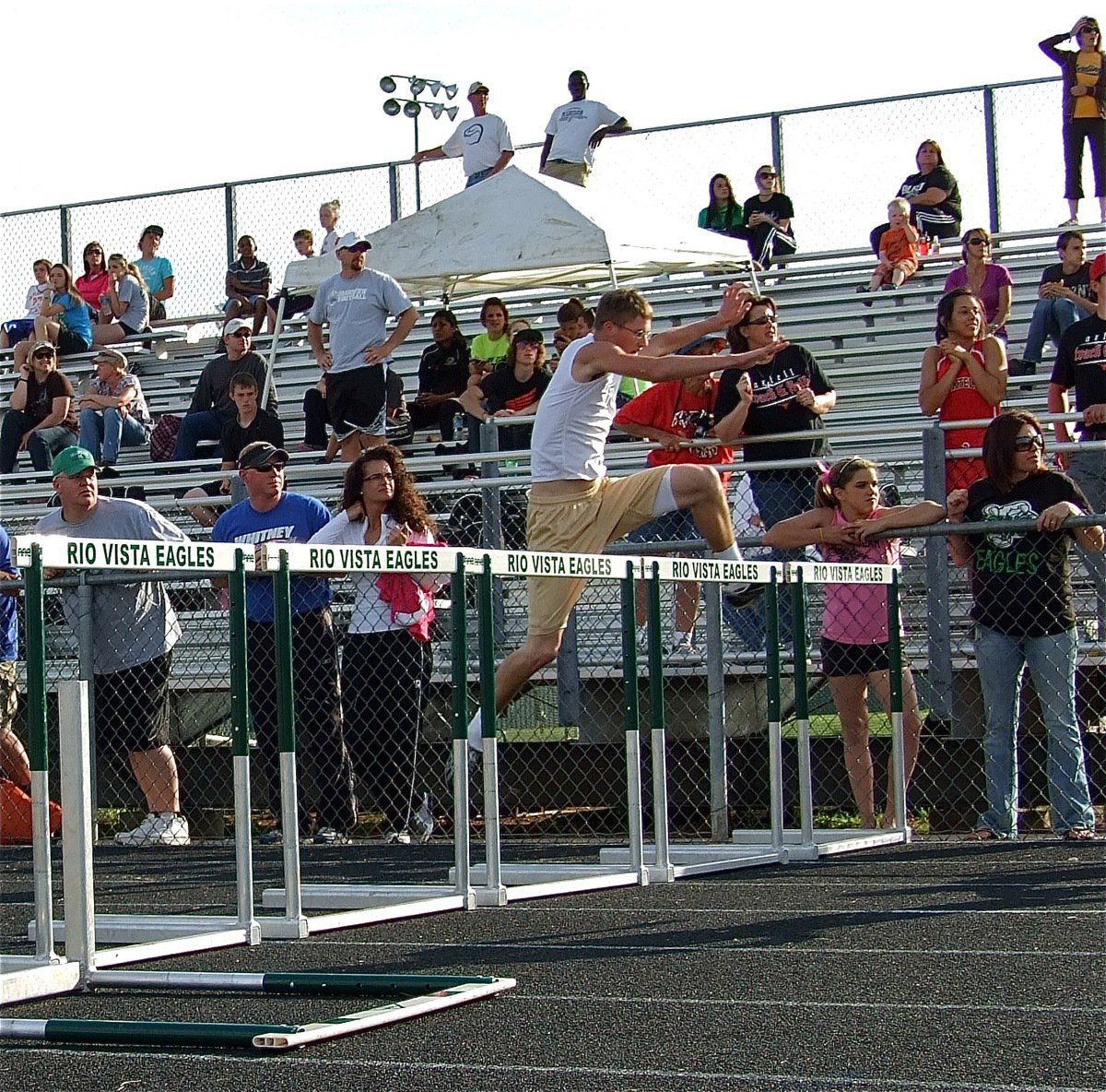 Image: Holden goes for it — Italy junior, Jase Holden, gives the 110 meter hurdles a try.