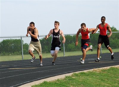 Image: The exchange — Hayden Wood hands the baton to Tony Wooldridge during the JV boys 400 meter relay. Wood and Wooldridge, along with teammates, Justin Wood and [Name Withheld], finished in 6th place.