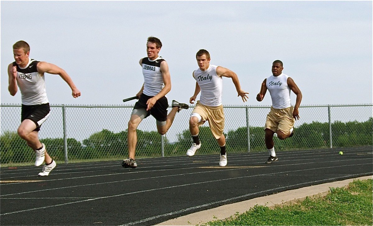 Image: Sticking together — Italy’s Jalarnce Jamal Lewis prepares to hand the baton to Chase Hamilton during the varsity boys 400 meter relay. Lewis and Hamilton, along with teammates, Jasenio Anderson and Heath Clemons, finished in 5th place.