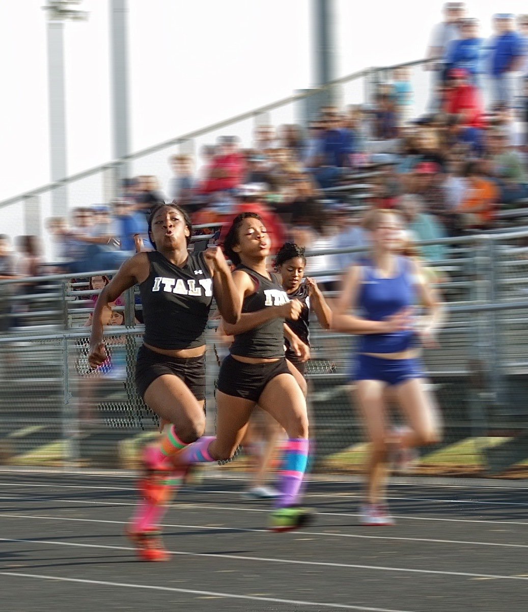 Image: Like the wind — Italy’s, Jameka Copeland, finishes in 1st place, Ryisha Copeland finishes in 2nd place and Ashley Harper finishes in 8th place during the JV girls 100 meter dash.