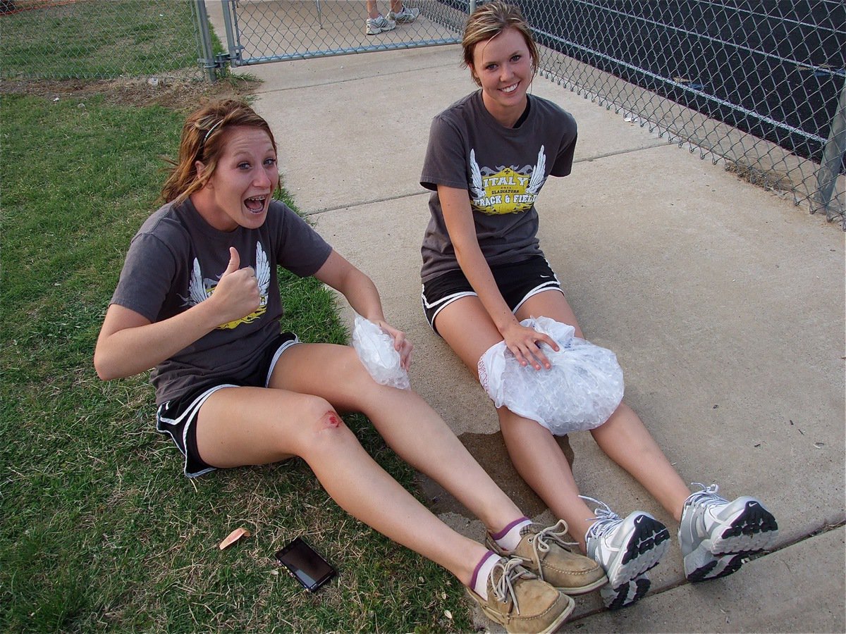 Image: Battle scars — Bailey Bumpus, with the miniature ice bag, tries to soothe her skinned knees she received before and after one of her races while teammate Kaitlyn Rossa gets to use the really big ice bag on her knees.