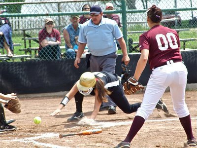 Image: Head first slide — Alyssa Richards slides head first to beat the throw at home.
