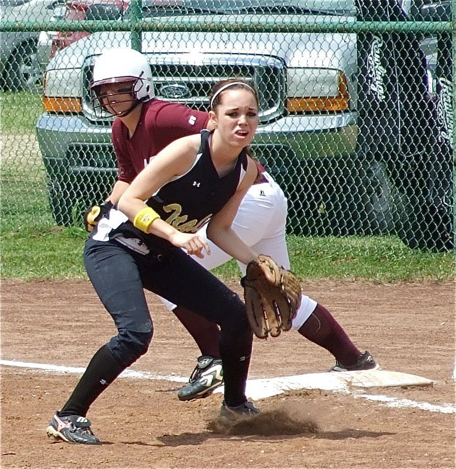 Image: Drew holds runner — First baseman Drew Windham holds the runner close to the bag while reacting to the pitch.