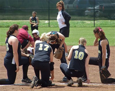 Image: Crash landing — A Mildred Lady Eagle gets injured after a collision with Italy’s shortstop Anna Viers who covered second base during the throw down, feathers where everywhere! The Lady Gladiators take a knee in a show of good sportsmanship.