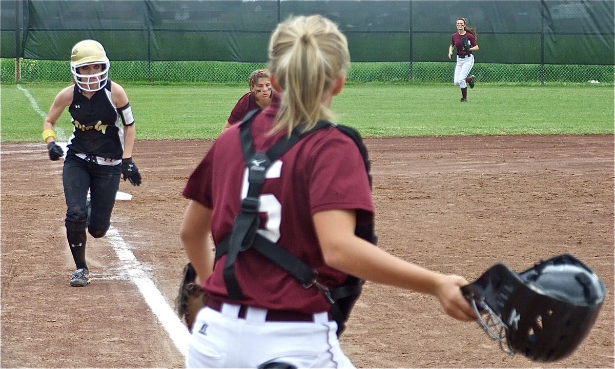 Image: Going for it — Drew Windham sprints home and the Lady Eagles are unable to stop her.