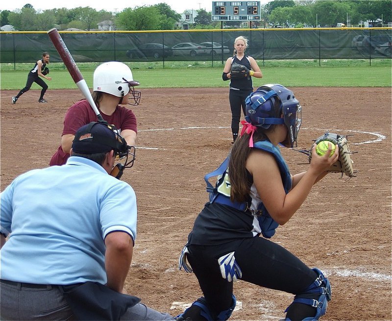 Image: Pulling the trigger — Catcher Alyssa Richards guns a throw down to first base to keep the Mildred runners honest.