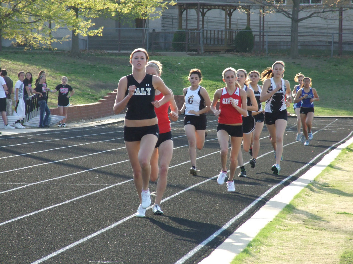 Image: Setting the pace — Italy’s Kaitlyn Rossa leads the varsity girls’ 800 meter run early but eventually settles for 2nd place.