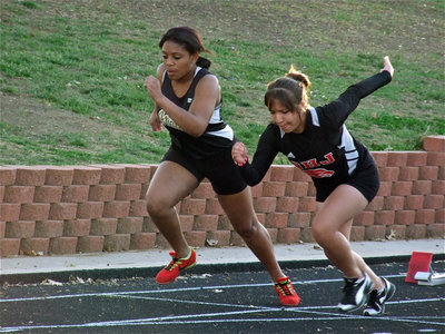 Image: Ashley takes off — Italy’s Ashely Harper, on the left, competes in the 100 meter dash and eventually earns 5th place overall in the event.