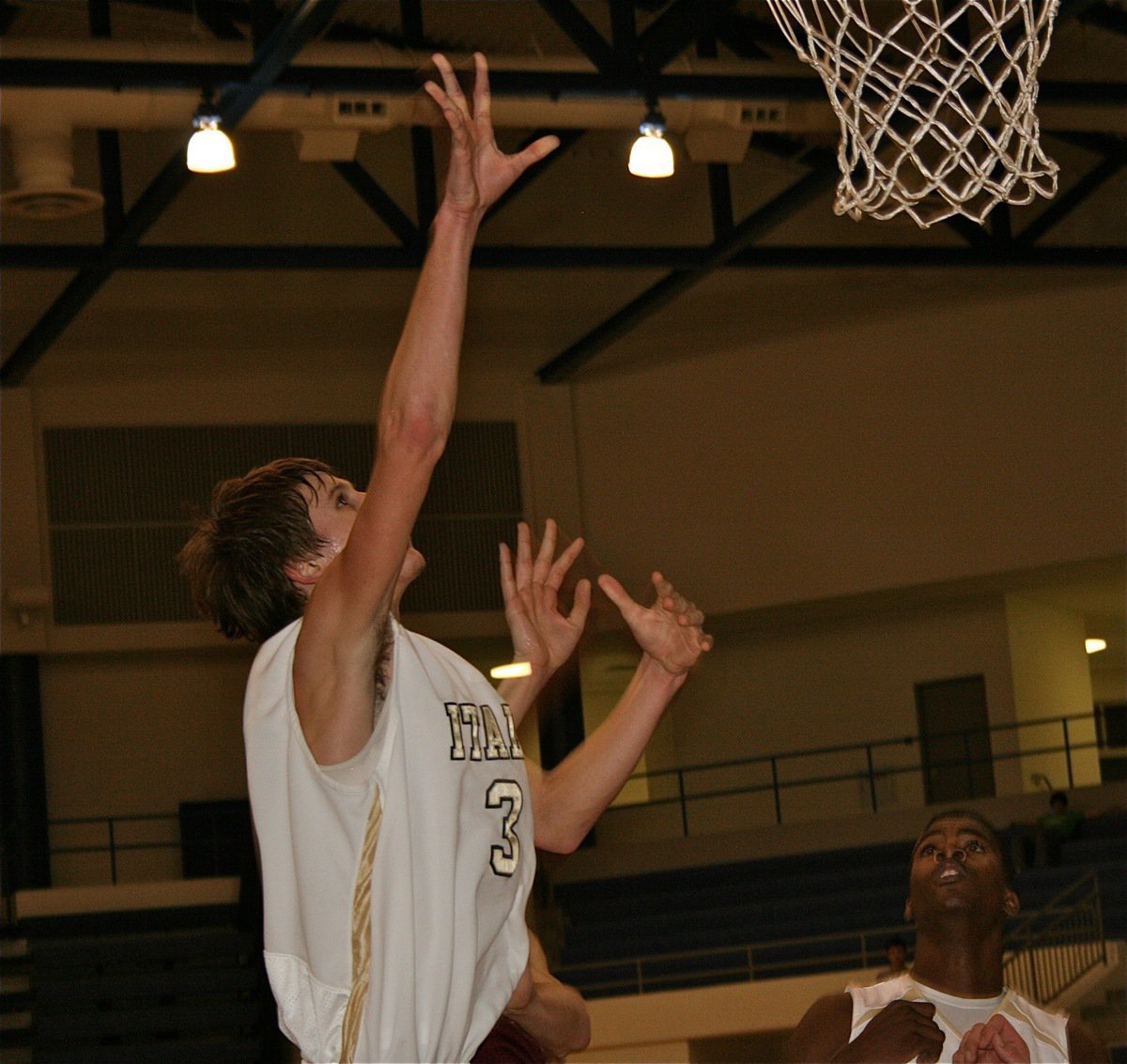 Image: Jase in the paint — Jase Holden(3) leaps high under the rim for a bucket while teammate Devonta Simmons tracks the ball.