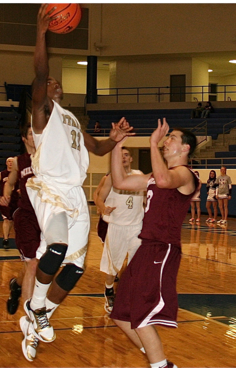 Image: Anderson fast breaks — Elevating his game, Jasenio Anderson(11) puts in a two of his 19-points scored in the second half.