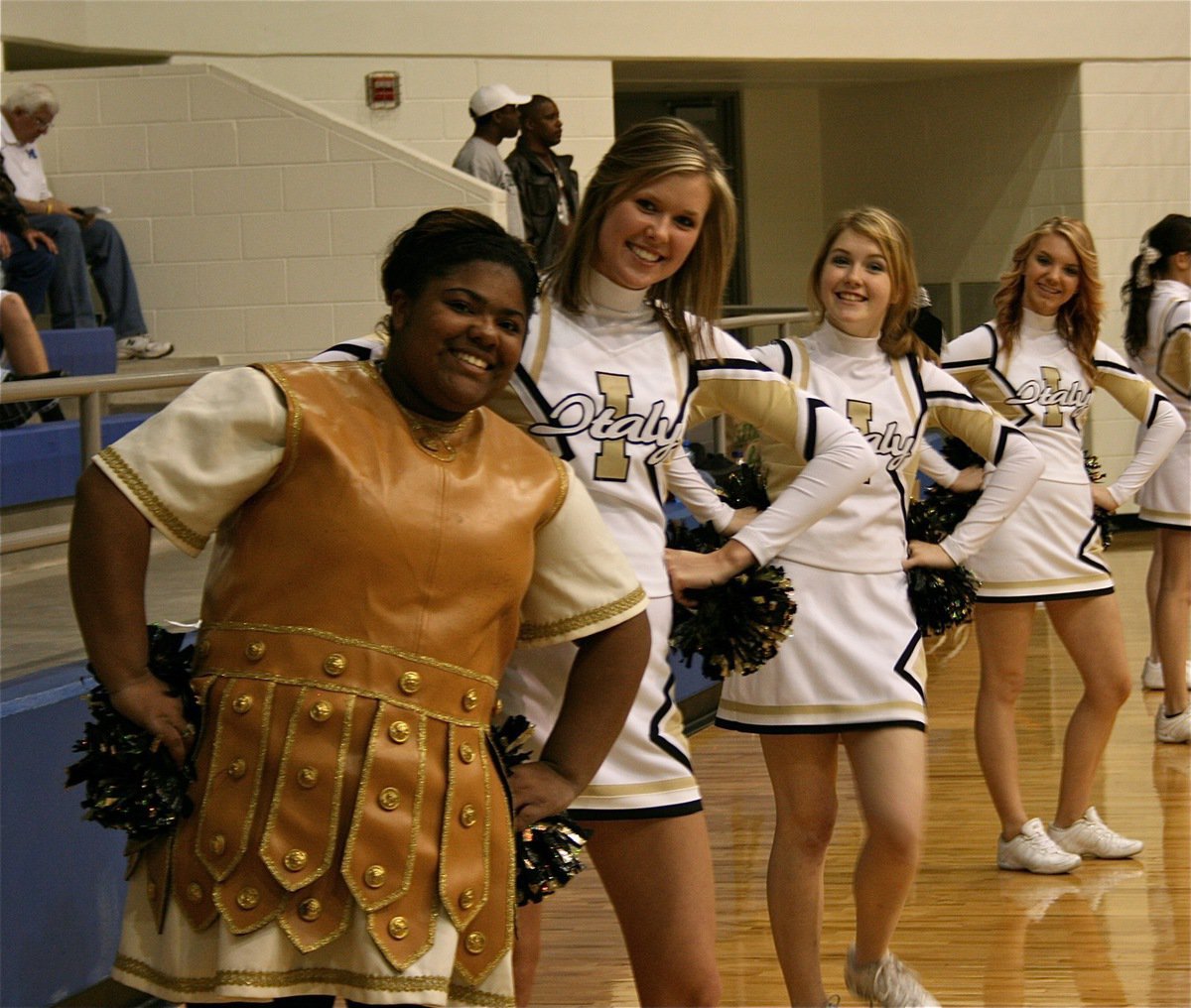 Image: Synchronized smiles — Gladiator mascot Sa’Kendra Norwood, and cheer mates Kaitlyn Rossa, Taylor Turner and Sierra Harris know how to strike a pose.