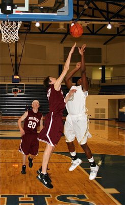 Image: Leaping Larry — Gladiator center Larry Mayberry(13) powers in a shot over the Mildred defense.
