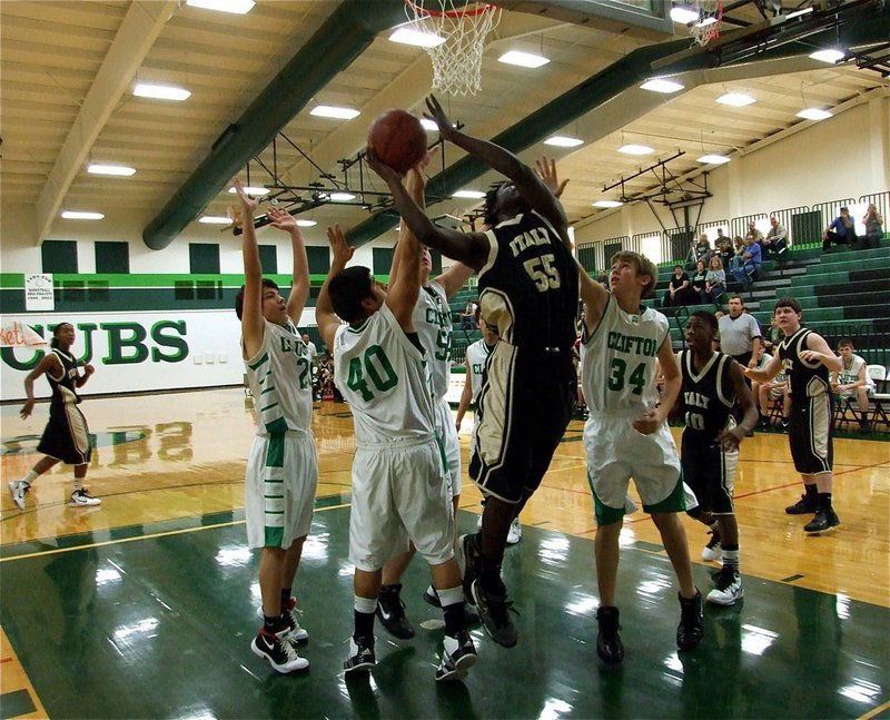 Image: In a crowd — Raheem Walker(55) gets the rebound and goes back up for Italy’s JV Gladiators.