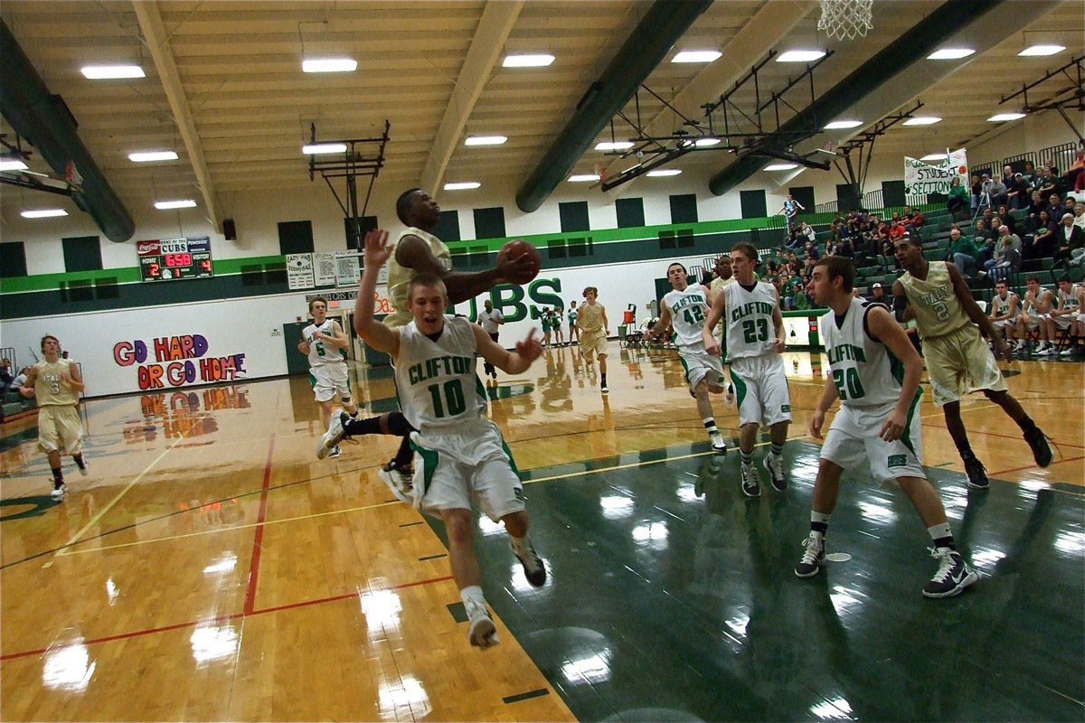 Image: Nice move — Gladiator point guard, Jasenio Anderson(11), avoids a Cubs’ defender and scores the layup.