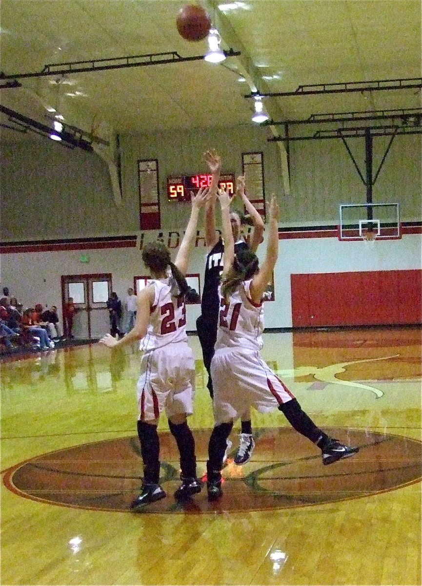 Image: Can’t stop her with two — Despite being completely corralled by two Lady Longhorn defenders, Kaitlyn Rossa(3) sticks the jumper from atop the lane.