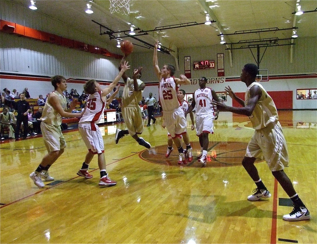 Image: Backwards shoes? — Heath Clemons(2) changes direction in midair to get the shot away.