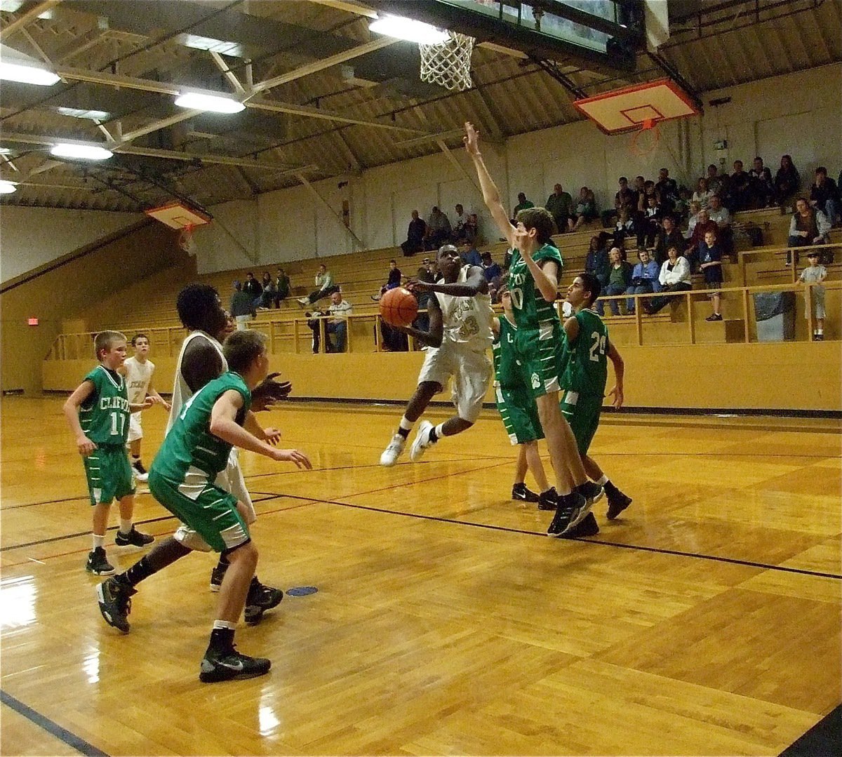 Image: Skill power — Italy’s T.J. Cockran(33) uses some aerial acrobatics to find the rim during the JV game.