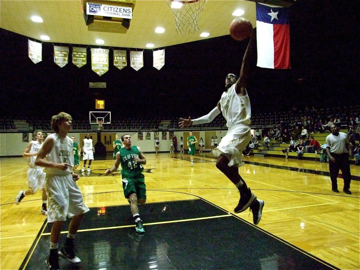 Image: On the up-and-up — Gladiator Heath Cemons(2) earns two style points against Clifton during the varsity matchup.