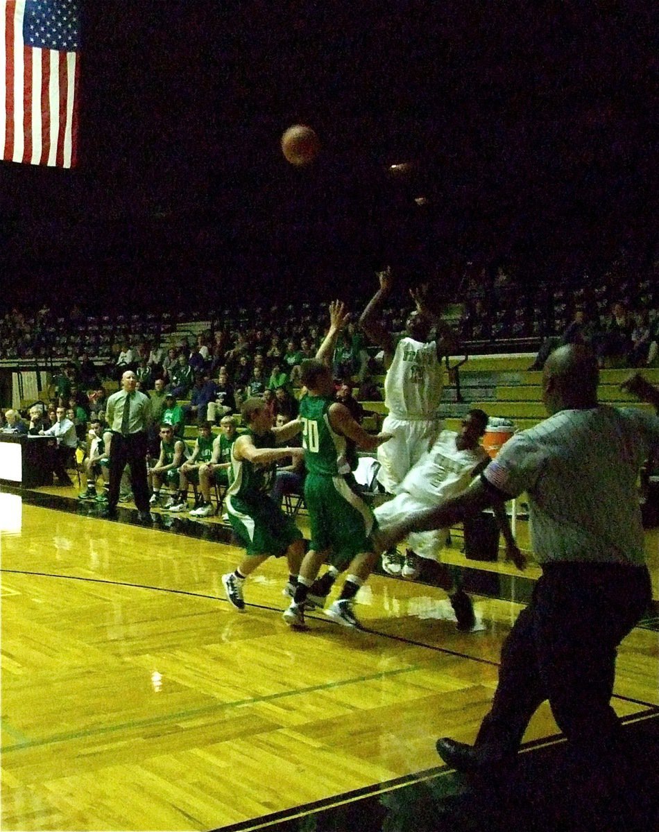 Image: Teaming up — Gladiator seniors Heath Clemons(2) and Jasenio Anderson(11) combine forces to get the shot away.