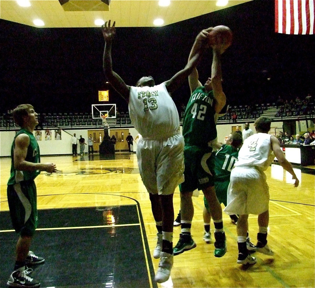 Image: Larry on the boards — Larry Mayberry(13) tries to rip down an offensive board for the Gladiators.