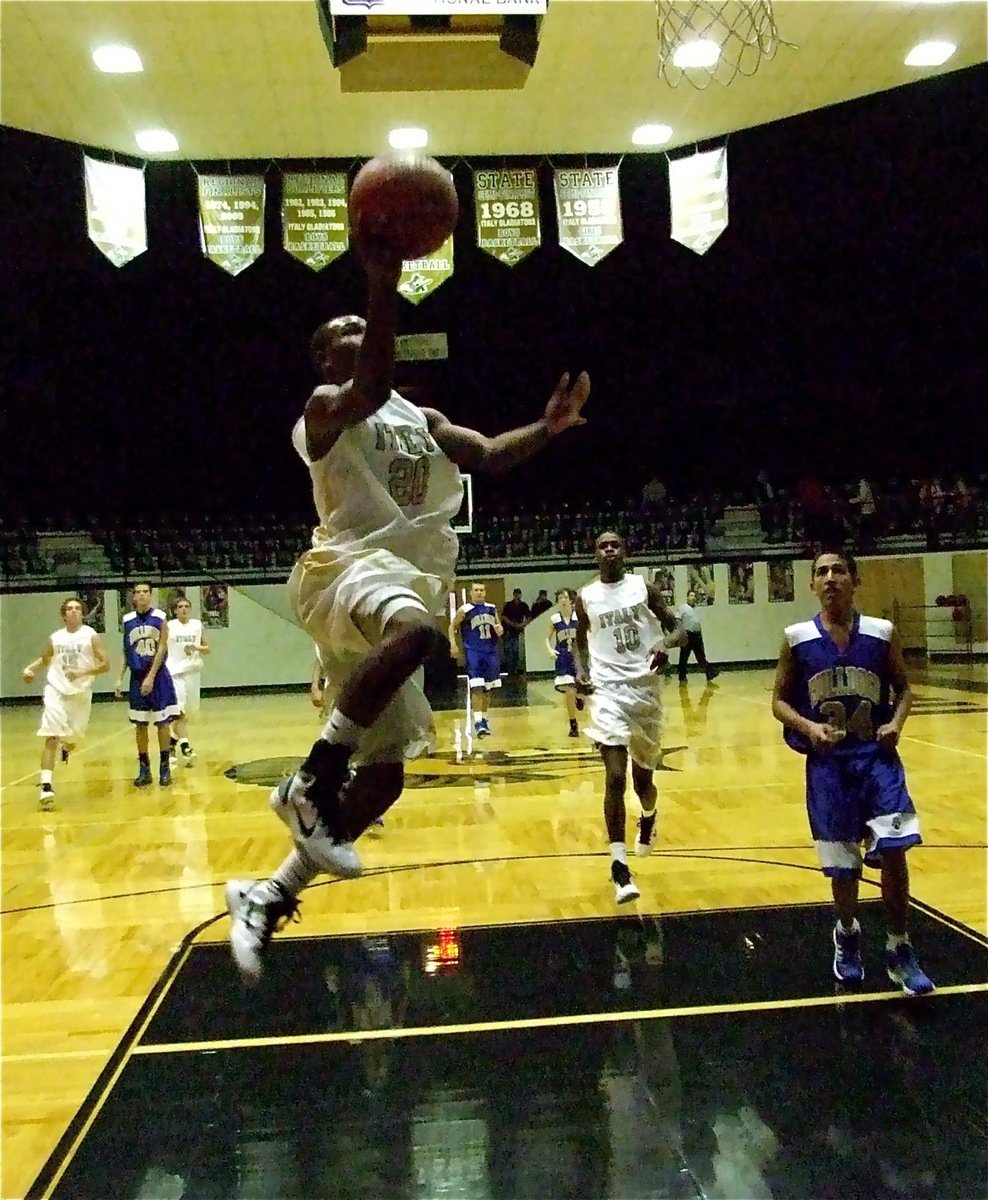 Image: 20 scores 22 — Gladiator De’Andre Sephus(20) climbs for two of his 22-points scored against the Venus J.V. Bulldogs. Sephus also knocked down two 3-pointers during the first round matchup.