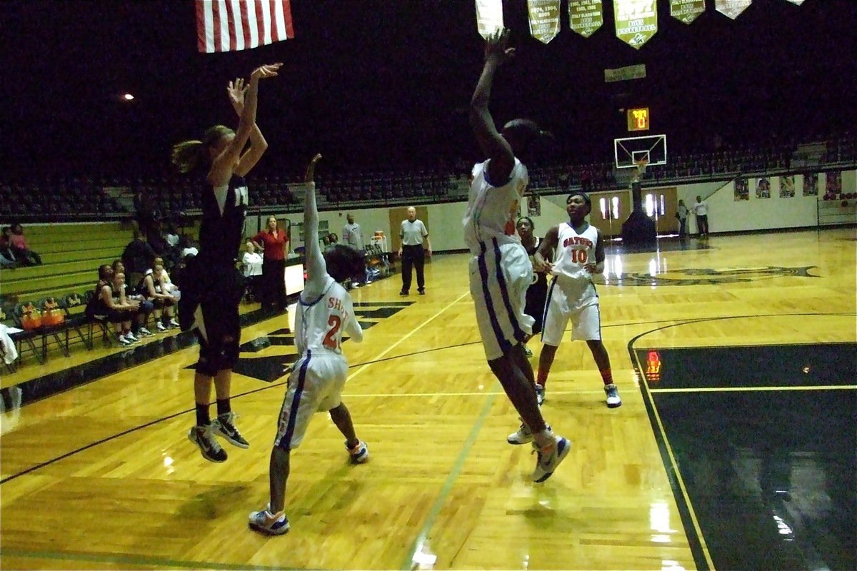 Image: Rossa rises — Lady Gladiator Kaitlyn Rossa(3) puts up a shot over two Lady Gator defenders.