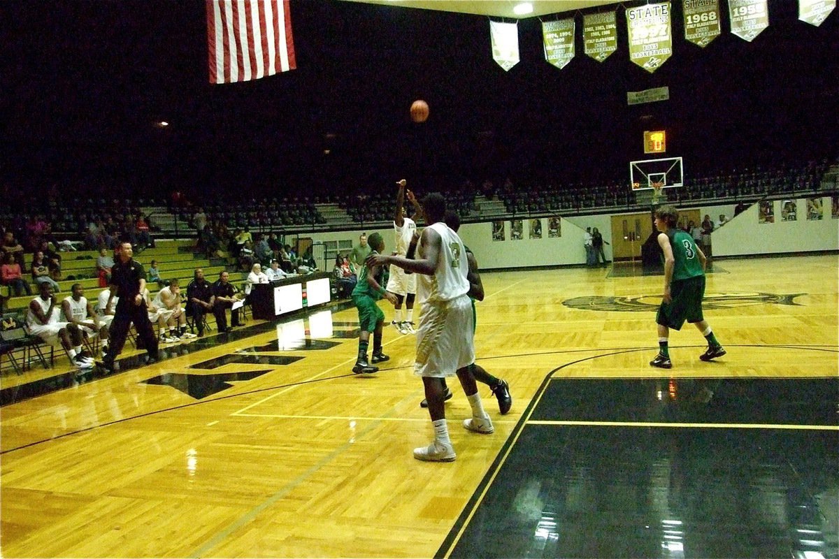 Image: Take that — Jasenio Anderson(11) takes a 3-point shot attempt over the Kerens defense.