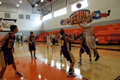 Image: Baseline weapon — Pulling up on the baseline, Bubba Itson(12) shoots a little floater over the Godley defense.