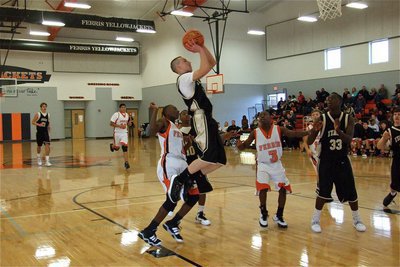 Image: Itson leaps — Bubba Itson(12) bounces off the block and toward the basket for 2-points.
