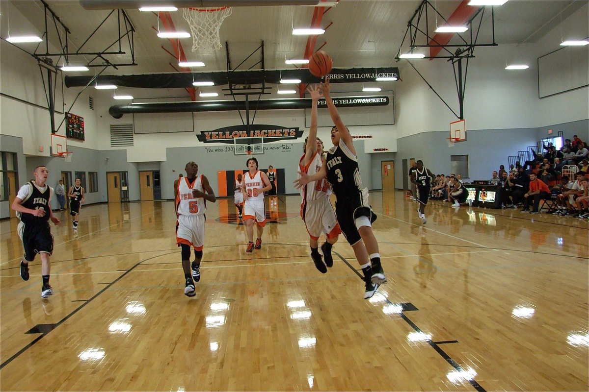 Image: Jacinto for two — Reid Jacinto(3) tries to finish a JV Gladiators fast break with a Ferris defender trailing him.