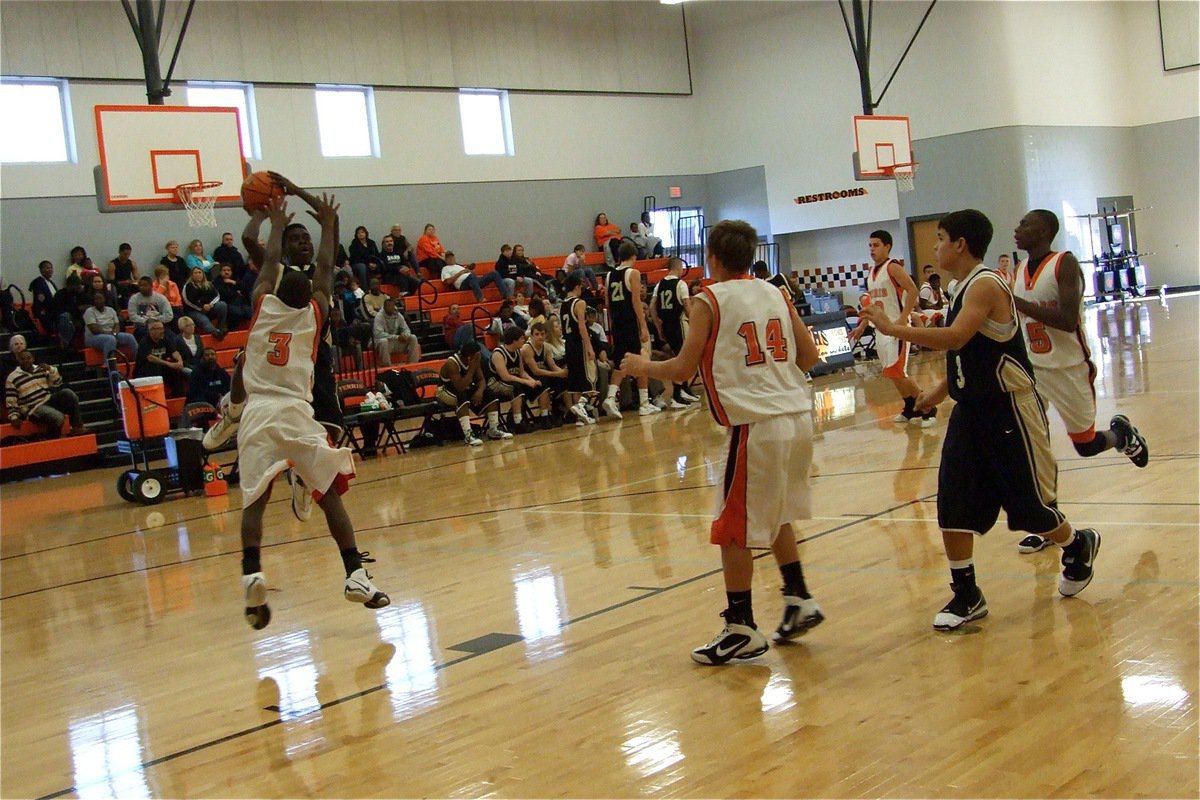 Image: Pouring it on — [Name Withheld] pulls up for a shot over a Ferris defender during the Ferris JV Basketball Tournament. Italy’s JV won 3-out-of-4 games to claim 3rd place.