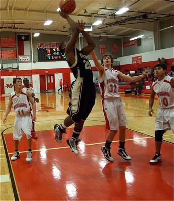 Image: Lewis is real deal — Jalarnce Jamal Lewis(20) scores a layup inside Maypearl’s red paint.
