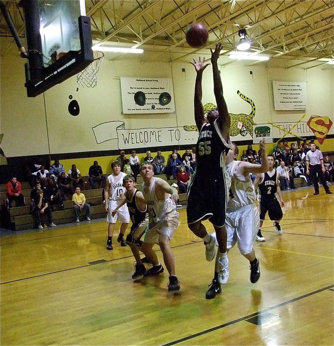 Image: Paul pulls it down — Italy’s Paul Harris(55) grabs a board out of the rafters during the JV game.